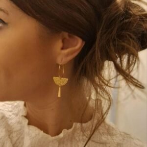 Créoles demi-cercle dorées portées à l'oreille
